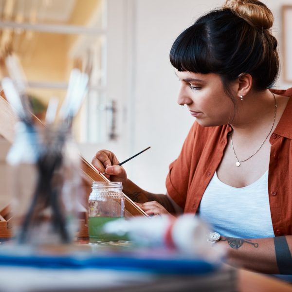 cropped-shot-of-an-unrecognizable-woman-working-on-a-painting-at-home.jpg