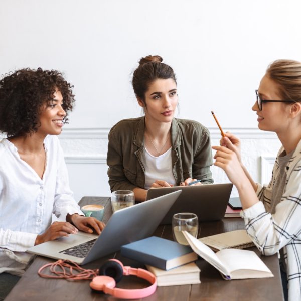 group-of-cheerful-young-women-studying-together.jpg